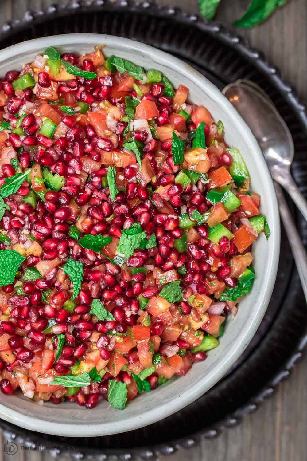 Colorful Pomegranate Tomato Salad in a bowl ready to be served