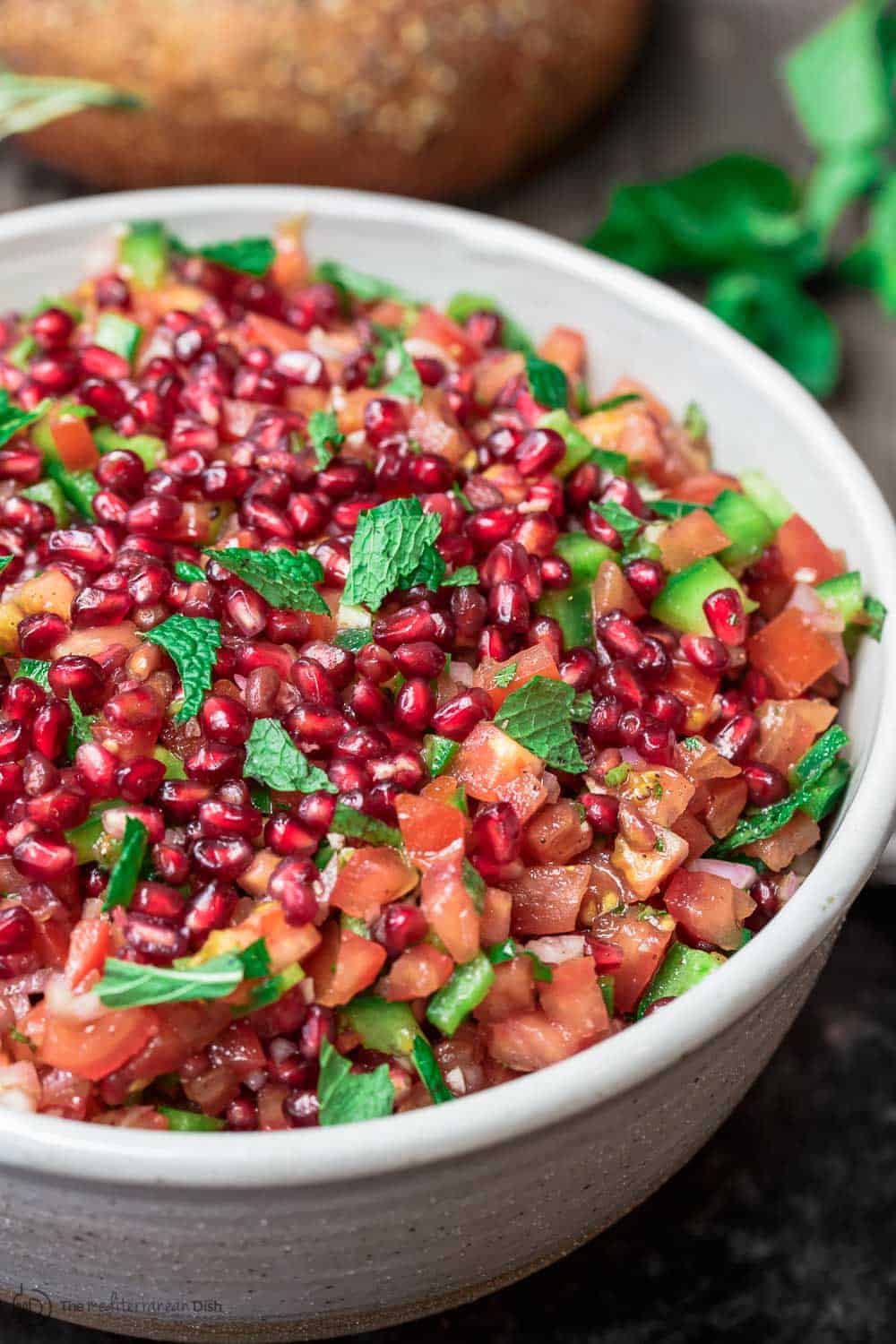 Tomato Salad topped with pomegranate seeds 