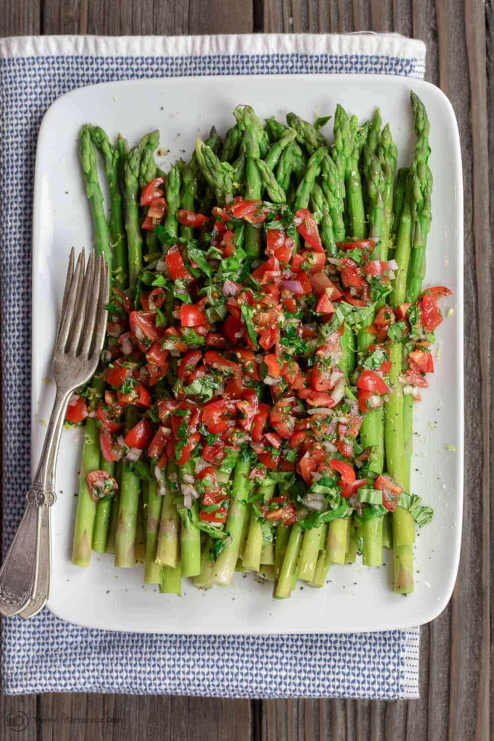 Blanched asparagus served with tomato salsa on top.