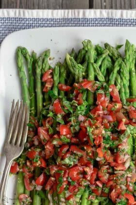 Easy Asparagus Recipe with Mediterranean Salsa | The Mediterranean Dish. Give asparagus a quick blanch, then top with this amazing Mediterranean salsa. Tons of flavor and texture! Serve as an appetizer, side, or Asparagus salad! Recipe from TheMediterraneanDish.com #asparagus #asparagusrecipe #mediterraneandiet #mediterraneanrecipe #mediterranean #mediterraneanfood #glutenfreerecipe #easyrecipe #sidedish #mediterraneansalad #healthyrecipes #veganrecipes