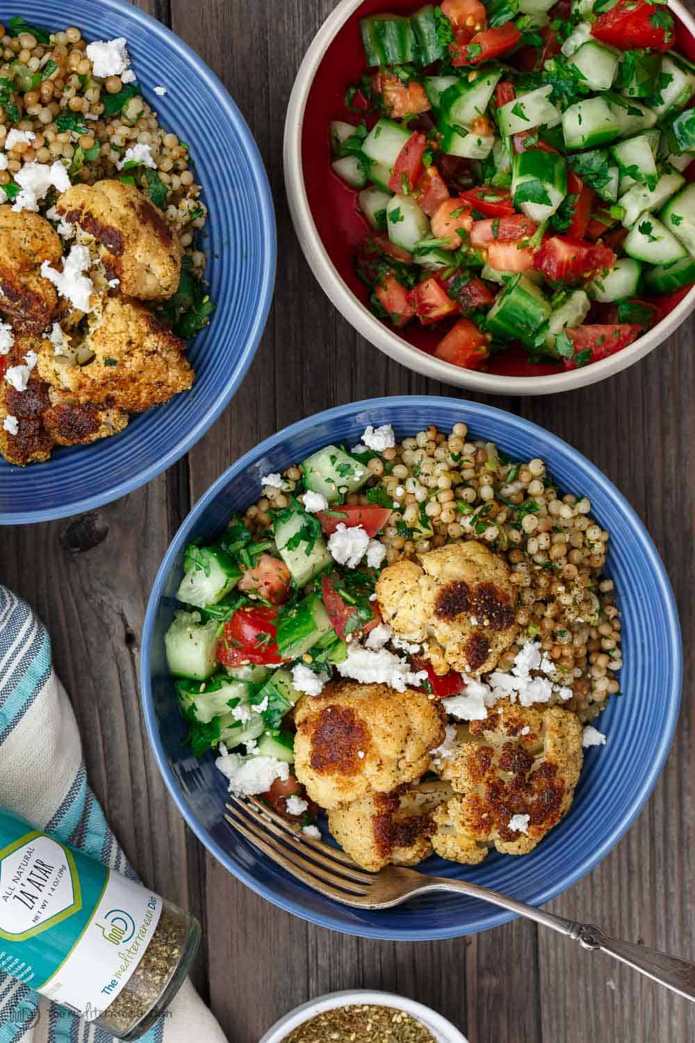 Herbed Couscous and cauliflower served with a cucumber and tomato salad