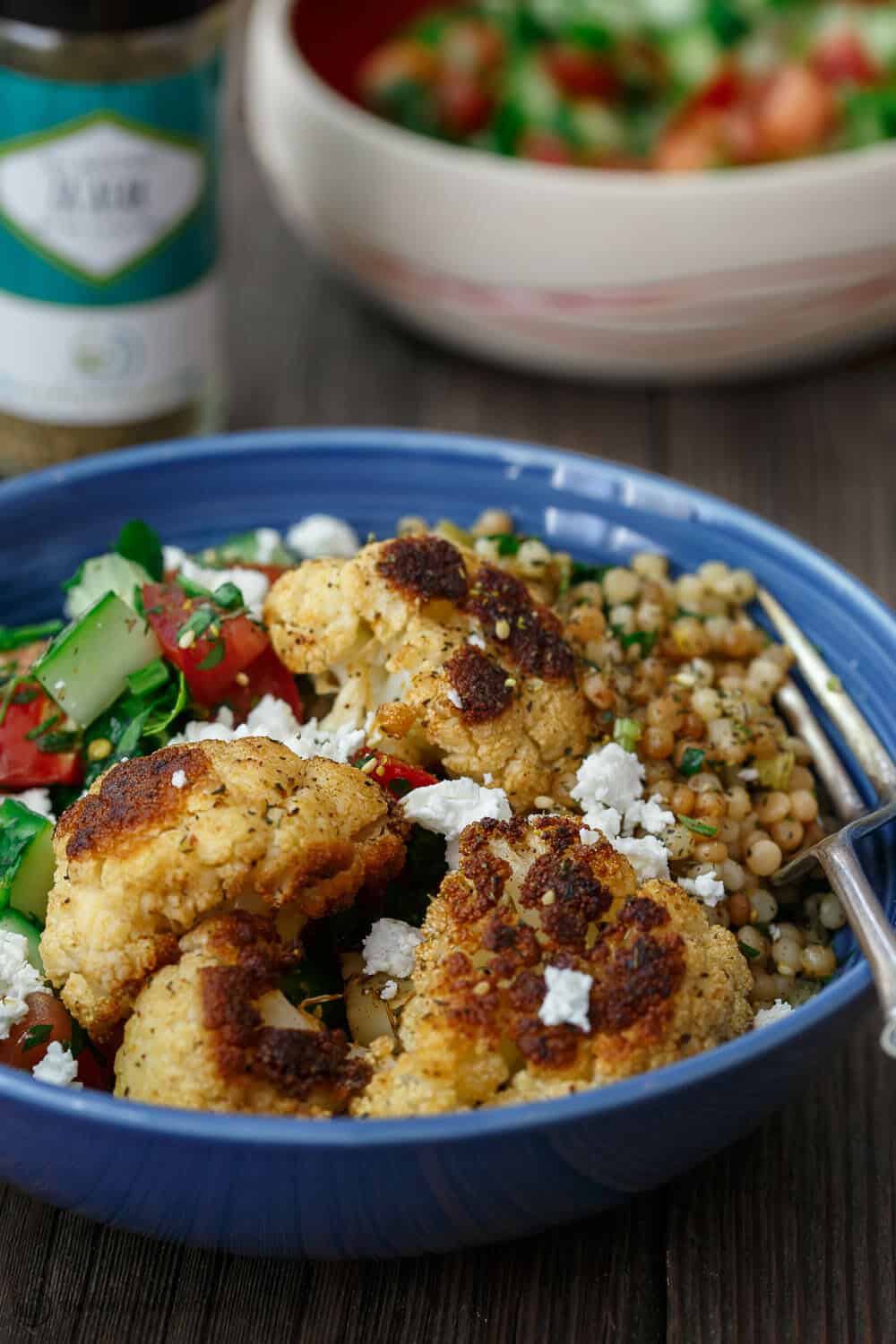 Bowl of Couscous and Roasted Cauliflower garnished with feta cheese