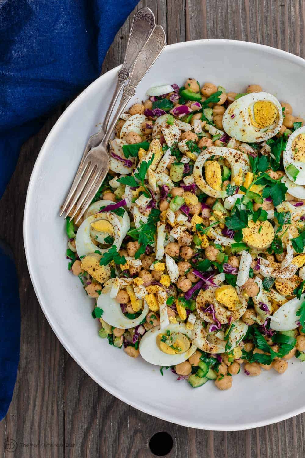 Bowl of Mediterranean Chickpea Egg Salad Garnished with cayenne pepper