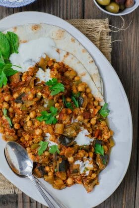 Greek Style Braised Eggplant Recipe | The Mediterranean Dish.All star braised eggplant recipe, prepared Greek style! Eggplants cooked to velvety tender perfection with chickpeas and tomato with aromatics and a few awesome spices. A perfectly satisfying meatless dinner or side dish. Vegan. Gluten Free. #meatless #eggplantrecipe #chickpearecipe #mediterraneandiet #greekfood #veganrecipe #glutenfreerecipe #chickpeas #eggplant #meatlessdinner #onepot #easyrecipes #healthyrecipe #vegetarian