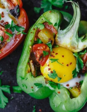 Easy Stuffed Peppers | The Mediterranean Dish. These stuffed peppers are filled with a gluten free and vegetarian potato hash and topped with a perfectly melty egg. Serve them for brunch or dinner, you'll love these healthy stuffed peppers, prepared Mediterranean style. See it on TheMediterraneanDish.com #stuffedpeppers #mediterraneandiet #breakfast #brunch #potatoes #potatohash #glutenfree #breakfasthash #easyrecipes #bellpeppers #healthyrecipe #vegetarian #mothersdaybrunch