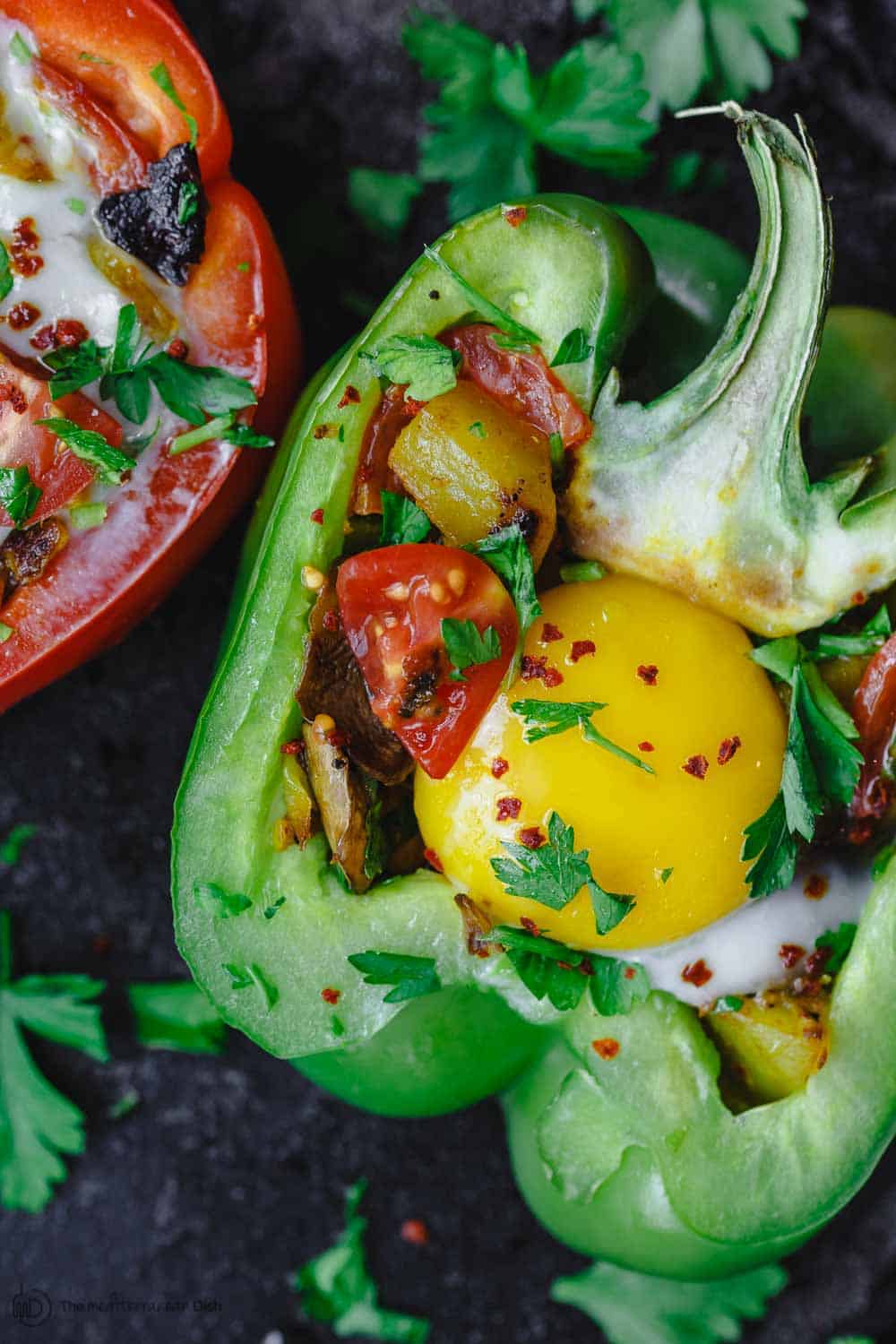 Easy Stuffed Peppers | The Mediterranean Dish. These stuffed peppers are filled with a gluten free and vegetarian potato hash and topped with a perfectly melty egg. Serve them for brunch or dinner, you'll love these healthy stuffed peppers, prepared Mediterranean style. See it on TheMediterraneanDish.com #stuffedpeppers #mediterraneandiet #breakfast #brunch #potatoes #potatohash #glutenfree #breakfasthash #easyrecipes #bellpeppers #healthyrecipe #vegetarian #mothersdaybrunch