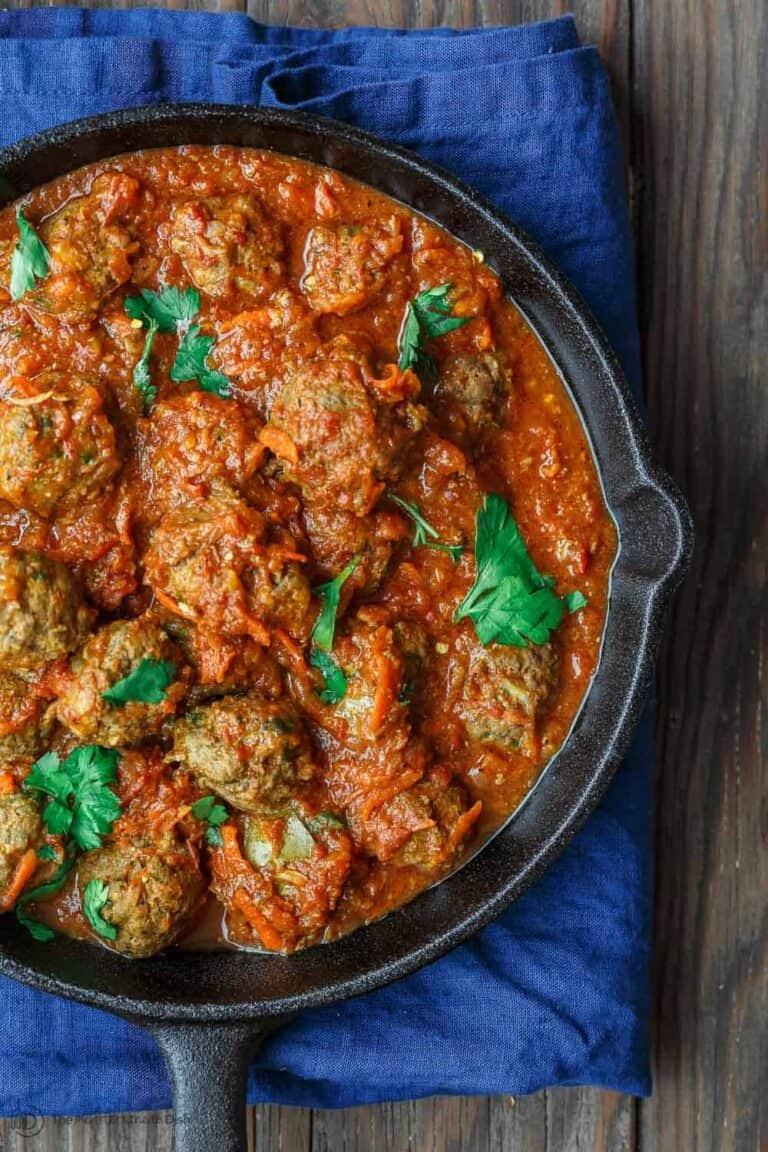 Lebanese-Style Meatballs Recipe in Tomato Sauce | The Mediterranean Dish. Juicy, tender meatballs, prepared Lebanese-style with notes of cinnamon and allspice, then braised in a tasty, thick tomato sauce. A couple simple ingredients take this meatballs recipe over the top. From TheMediterraneanDish.com #easyrecipe #meatballs #mediterraneanrecipe #mediterraneandiet #lebanese #meatballsrecipe #onepot