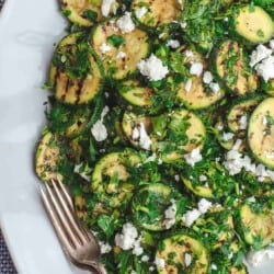 Mediterranean Style Grilled Zucchini Salad | The Mediterranean Dish. Simple, flavor-packed grilled zucchini with fresh herbs and other Mediterranean favorites. Ready in 15 minutes. Recipe from TheMediterraneanDish.com