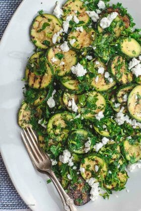 Mediterranean Style Grilled Zucchini Salad | The Mediterranean Dish. Simple, flavor-packed grilled zucchini with fresh herbs and other Mediterranean favorites. Ready in 15 minutes. Recipe from TheMediterraneanDish.com