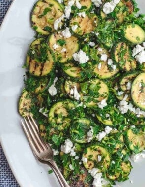 Mediterranean Style Grilled Zucchini Salad | The Mediterranean Dish. Simple, flavor-packed grilled zucchini with fresh herbs and other Mediterranean favorites. Ready in 15 minutes. Recipe from TheMediterraneanDish.com