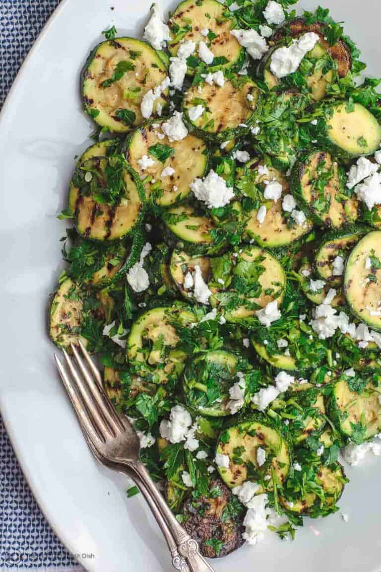Mediterranean Style Grilled Zucchini Salad | The Mediterranean Dish. Simple, flavor-packed grilled zucchini with fresh herbs and other Mediterranean favorites. Ready in 15 minutes. Recipe from TheMediterraneanDish.com
