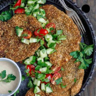 Za'atar Breaded Chicken Recipe | The Mediterranean Dish. Best breaded chicken you'll ever have! Chicken cutlets are prepared to tender perfection and given a golden, perfectly crispy breading with za'atar and toasted sesame seed. See our suggestions for sides and salads. Recipe from TheMediterraneanDish.com #chickenrecipes #breadedchicken #chickendinner #mediterraneanfood #30minutemeal #chicken