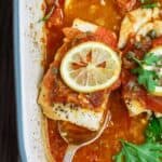 Mediterranean Baked Fish Recipe with Tomatoes and Capers | The Mediterranean Dish. Easy, bright, flavor-packed baked fish, prepared Mediterranean style with spices, tomatoes and capers. From TheMediterraneanDish.com #healthyrecipes #fishrecipe #bakedfish #cod #halibut #glutenfree #seafoodrecipe #seafood #fish #mediterraneandiet #mediterranean #easyrecipe