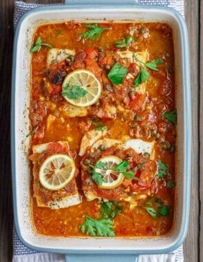 Mediterranean Baked Fish Recipe with Tomatoes and Capers | The Mediterranean Dish. Easy, bright, flavor-packed baked fish, prepared Mediterranean style with spices, tomatoes and capers. From TheMediterraneanDish.com #healthyrecipes #fishrecipe #bakedfish #cod #halibut #glutenfree #seafoodrecipe #seafood #fish #mediterraneandiet #mediterranean #easyrecipe