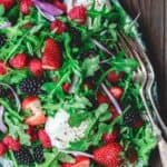 Burrata Arugula Berry Salad | The Mediterranean Dish. This berry salad recipe is a must-try! The perfect summer salad with loads of berries, peppery arugula, and burrata cheese. A light citrus and olive oil dressing is all you need!