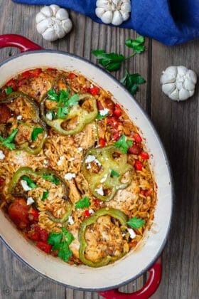 Greek Baked Chicken Orzo Recipe | The Mediterranean Dish. The perfect one-pot chicken and orzo dinner. Perfectly seasoned chicken, nestled into a mixture of tiny orzo pasta with onions, bell peppers, and tomato. This is a dinner for any night of the week. Easy, and absolutely satisfying. From themediterraneandish.com #greekfood #mediterraneanfood #mediterraneandiet #chickendinner #chickenrecipe #healthyrecipe #onepotdinner #easydinner