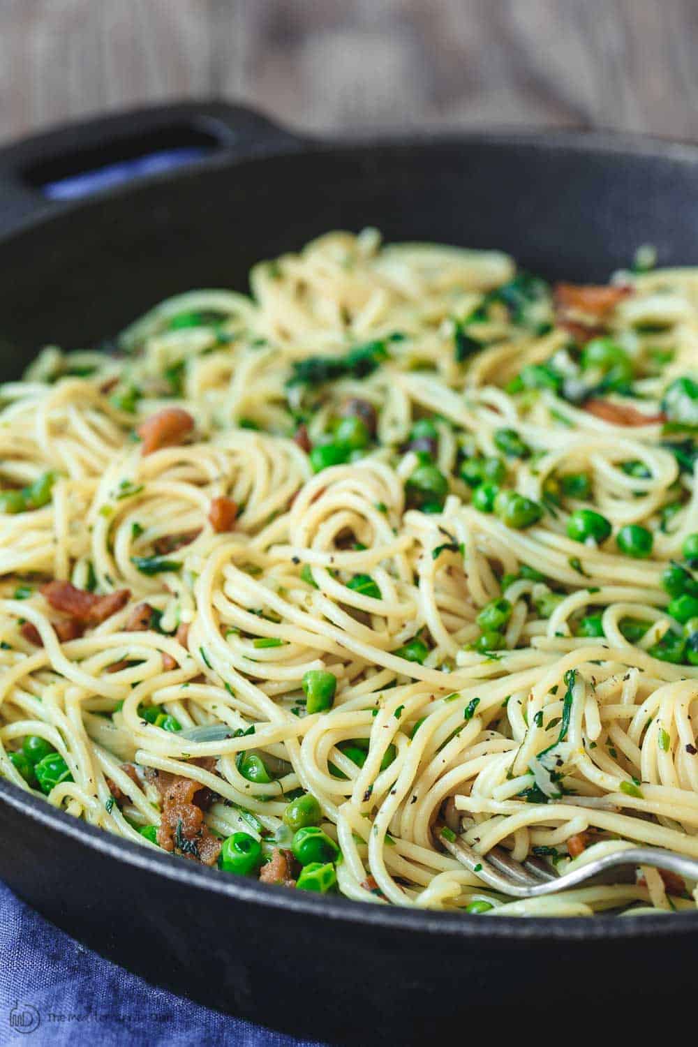 Close-up of peas and pancetta served on pasta