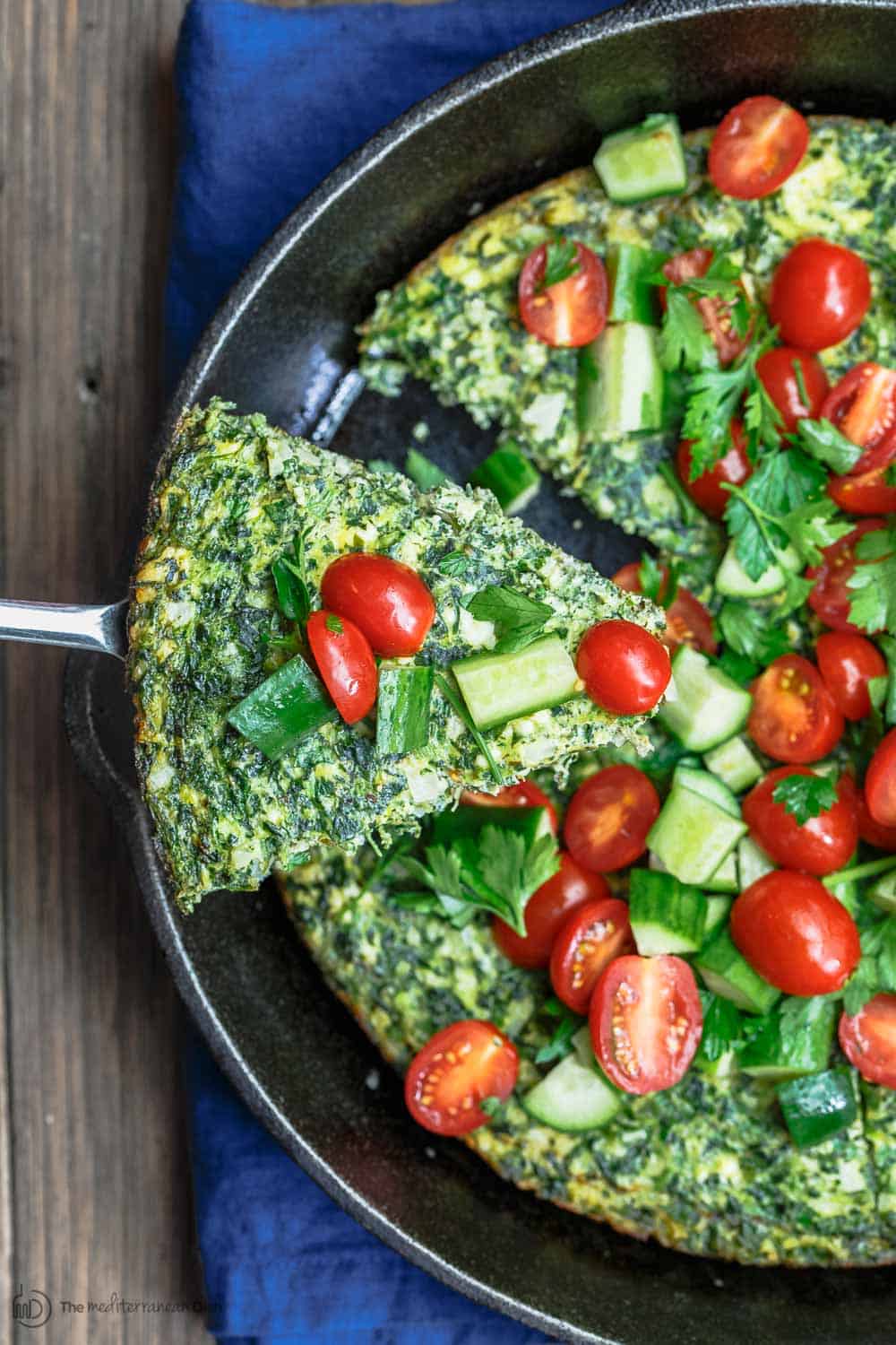 Feta and Spinach Frittata Recipe | The Mediterranean Dish. Easy, flavor-packed fritta with feta, spinach, and parsley. The perfect breakfast or weeknight dinner in just 20 minutes. From TheMediterraneanDish.com #frittata #eggs #mediterraenandiet #mediterraenanfood #italianfood #spinach #feta #healthyrecipes #easyrecipes