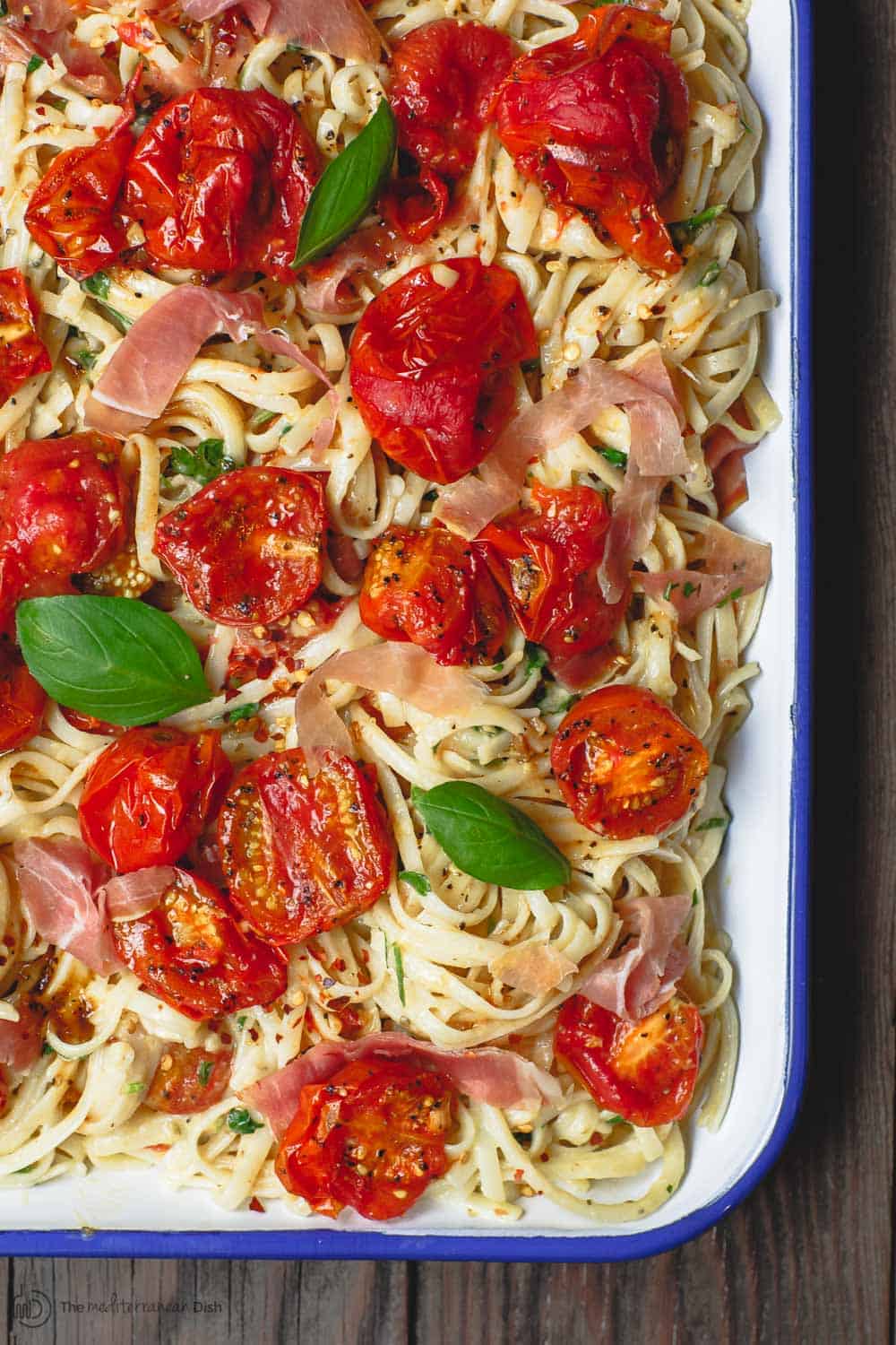 Carbonara Recipe with Roasted Tomatoes | The Mediterranean Dish. A lighter, and flavor-packed cabornara recipes with garlic roasted tomatoes and fresh herbs. You can add ribbons of prosciutto, if you like. A couple of tricks make a perfectly creamy carbonara. Recipe from themediterraneandish.com #pasta #pastarecipe #italianfood #mediterraneandiet #carbonara #easyrecipe