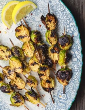 Grilled Brussels Sprouts Skewers | The Mediterranean Dish. Easy, flavor-packed burssels sprouts. Marinated, Mediterranean style, then charred to perfection and finished with Parmesan cheese. Recipe from themediterraneandish.com