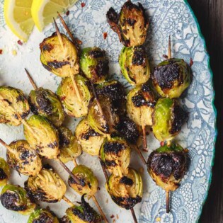 Grilled Brussels Sprouts Skewers | The Mediterranean Dish. Easy, flavor-packed burssels sprouts. Marinated, Mediterranean style, then charred to perfection and finished with Parmesan cheese. Recipe from themediterraneandish.com