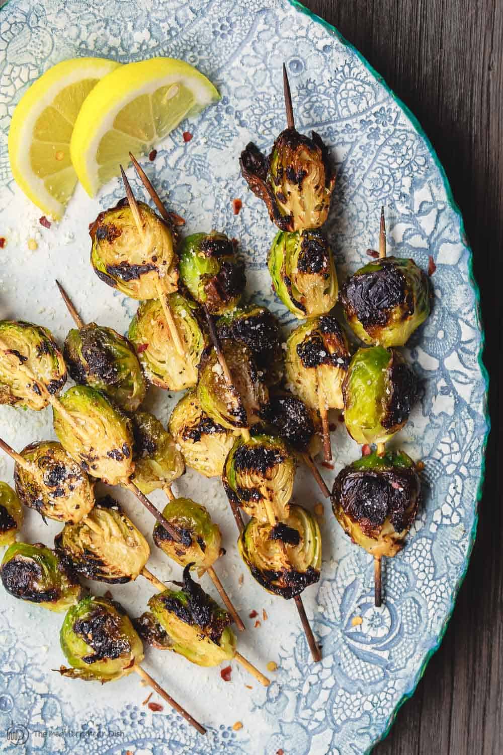 Grilled Brussels Sprouts Skewers | The Mediterranean Dish. Easy, flavor-packed burssels sprouts. Marinated, Mediterranean style, then charred to perfection and finished with Parmesan cheese. Recipe from themediterraneandish.com