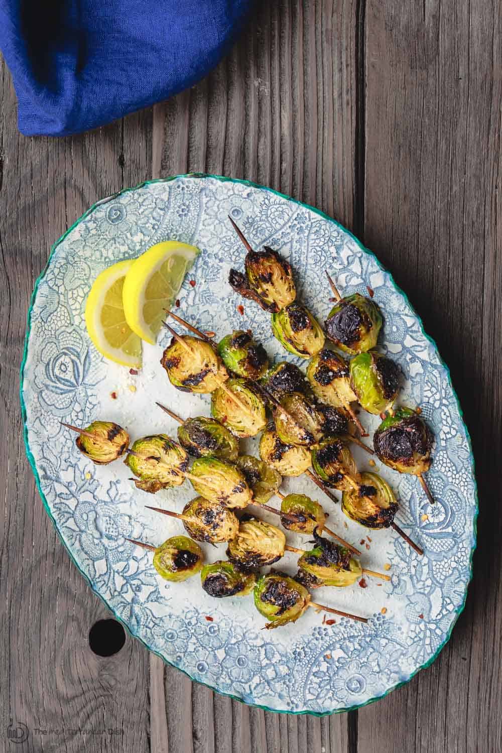 Grilled Brussels Sprouts Skewers | The Mediterranean Dish. Easy, flavor-packed burssels sprouts. Marinated, Mediterranean style, then charred to perfection and finished with Parmesan cheese. Recipe from themediterraneandish.com