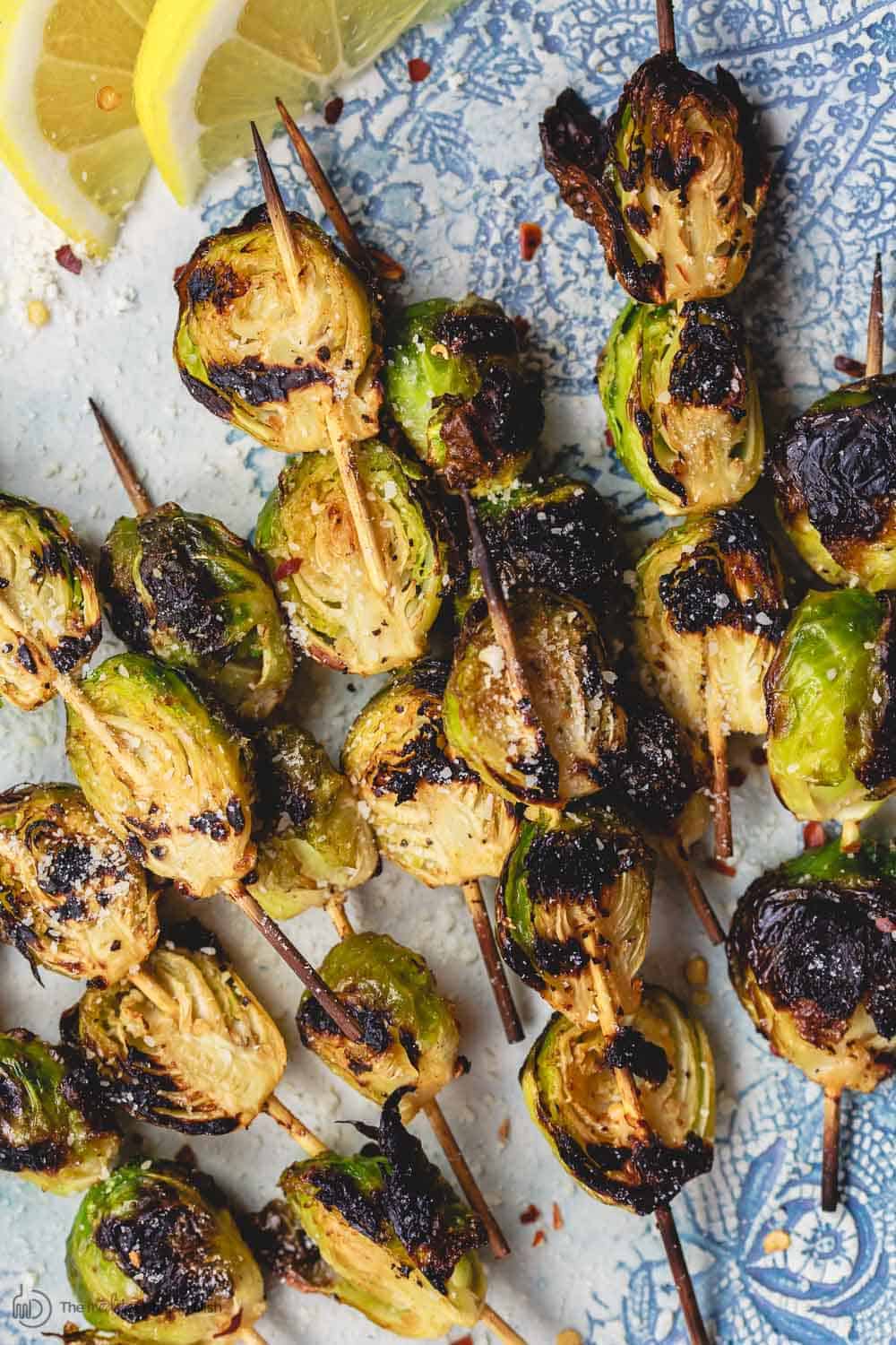 Grilled Brussels Sprouts Skewers | The Mediterranean Dish. Easy, flavor-packed burssels sprouts. Marinated, Mediterranean style, then charred to perfection and finished with Parmesan cheese. Recipe from themediterraneandish.com