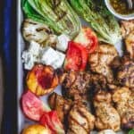 Grilled Harissa Chicken Recipe | The Mediterranean Dish. Easy, flavor-packed Mediterranean grilled chicken. Add grilled vegetables and peaches or serve with your favorite salad. Get the recipe on themediterraneandish.com #grilledchicken #mediterraneanchicken #mediterraneandiet #easydinner #heatlhyrecipes #grilledpeaches #grilledlettuce