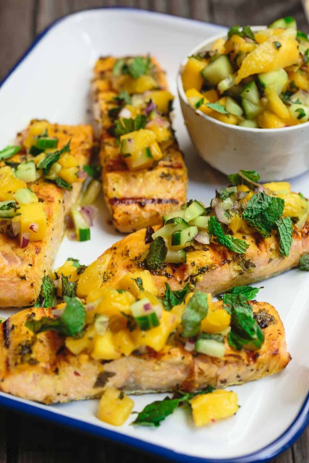 salmon pieces cooked on the grill and topped with mango salsal