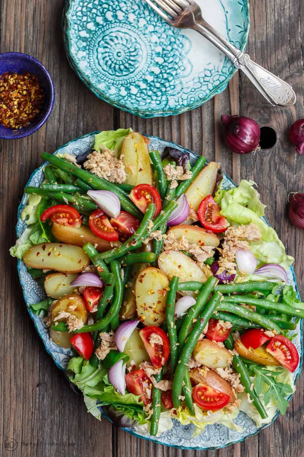 Spanish Potato Salad Recipe with Tuna | The Mediterranean Dish. Easy, tasty potato salad with tuna, green beans, and tomatoes. Lots of flavor from earthy spices and a simple Spanish-inspired dressing. Great as an appetizer or a light dinner. Recipe from TheMediterraneanDish.com #mediterraneandiet #mediterraneansalad #spanishsalad #potatosalad #glutenfree #tunasalad #healthyrecipes #greenbeans