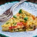 Crustless Zucchini Quiche Recipe | The Mediterranean Dish. Simple crustless zucchini quiche recipe with fresh herbs, tomatoes, and shallots. Perfect for breakfast, lunch, or a light dinner. See our suggestions for what to serve along. #zucchini #quiche #crustlessquiche #zucchinirecipe #breakfast #brunch #holidaybrunch #vegetarianrecipes #savorypie #eggs #mediterraneandiet #mediterraneanrecipes