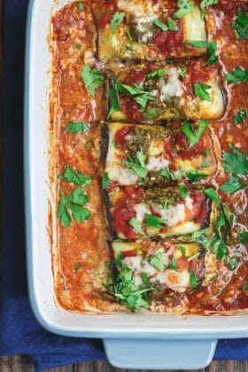 Eggplant Rollatini Recipe | The Mediterranean Dish. Flavor-packed, healthy eggplant rollatini that is perfect for dinner or as an appetizer. The secret is in the tasty rollatini filling with part-skim ricotta, basil pesto, and fresh parsley. Recipe from themediterraneandish.com #eggplant #mediterraneanfood #mediterraneandiet #italianfood #eggplantrollatini #glutenfreerecipes