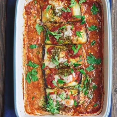 Eggplant Rollatini Recipe | The Mediterranean Dish. Flavor-packed, healthy eggplant rollatini that is perfect for dinner or as an appetizer. The secret is in the tasty rollatini filling with part-skim ricotta, basil pesto, and fresh parsley. Recipe from themediterraneandish.com #eggplant #mediterraneanfood #mediterraneandiet #italianfood #eggplantrollatini #glutenfreerecipes