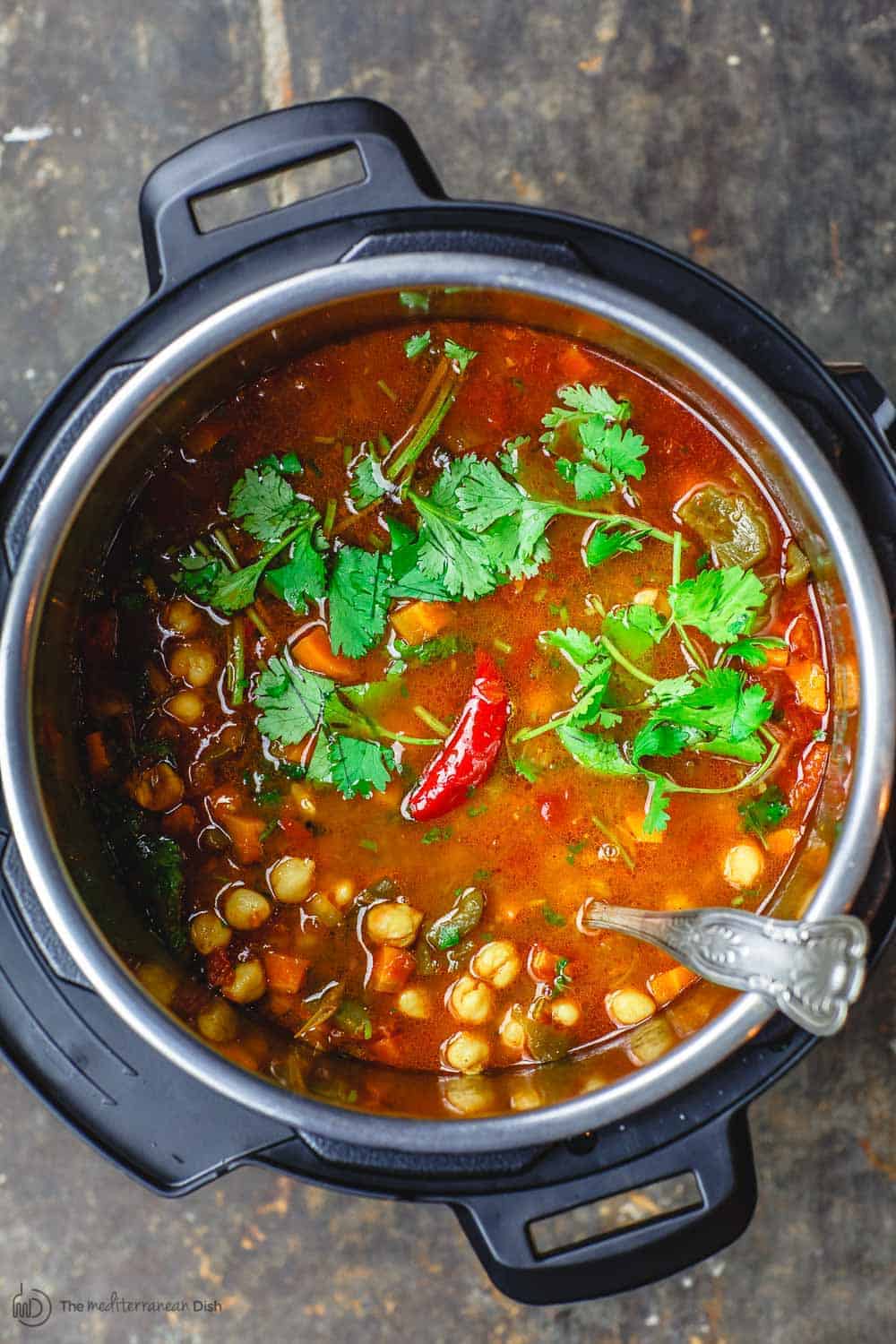 Easy Chickpea Instant Pot Soup | The Mediterranean Dish. Mediterranean style chickpea soup, with vegetables, fresh herbs, and great spices. You can make this in minutes in the Instant Pot, or see stovetop and slow cooker instructions. Great for make ahead and meal prep. #chickpeasoup #chickpearecipe #instantpotsoup #instantpotrecipe #instantpot #slowcooker #mediterraneandiet #veganrecipe #glutenfree #lowcarb