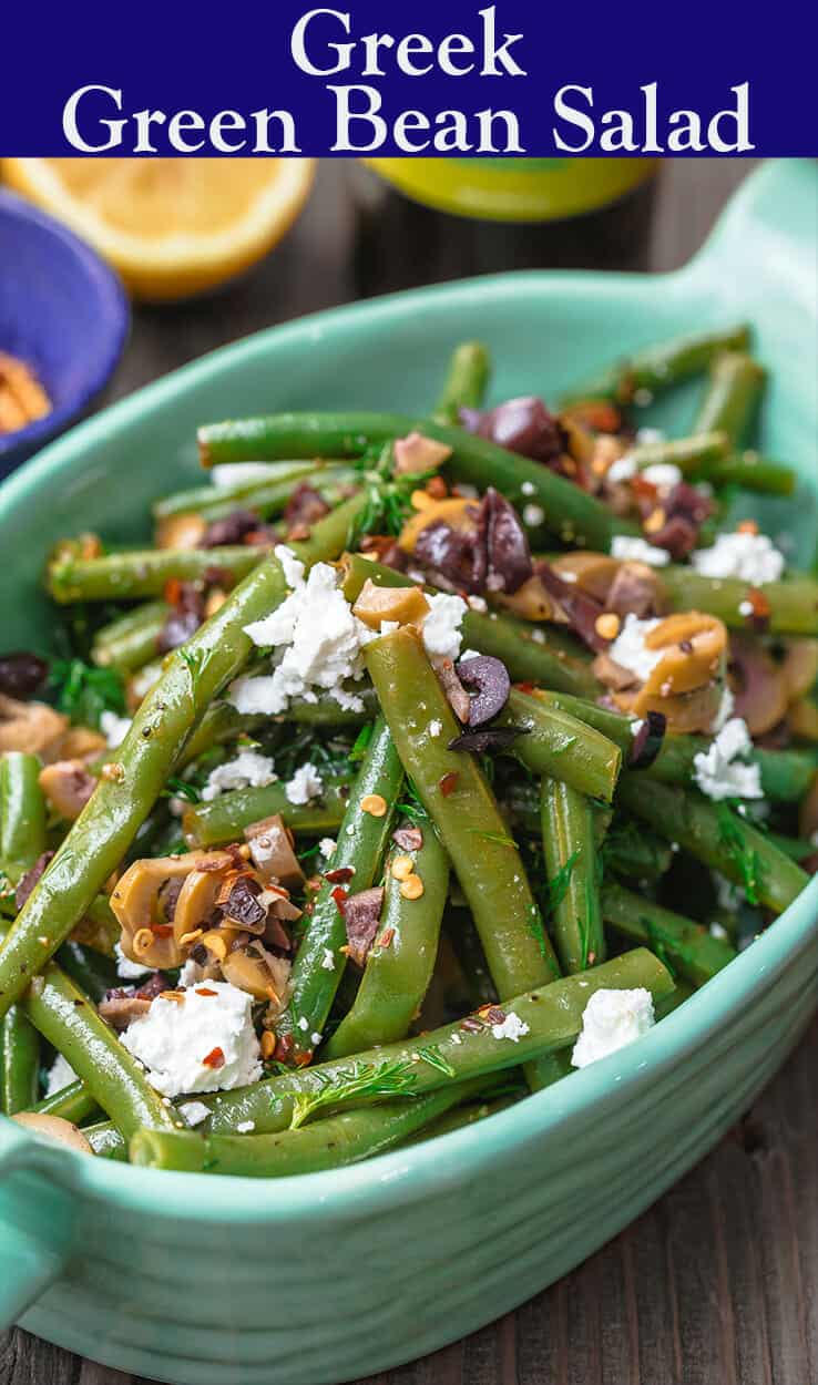 Greek Green Bean Salad Recipe | The Mediterranean Dish. Perfectly tender, flavor-packed green bean salad prepared Greek style. A garlicy, zesty dressing pulls it together, and a sprinkle of feta and chopped marinated olives take it to a new level of delicious. Get the easy recipe on themediterraneandish.com #greenbeans #greekfood #greekrecipe #mediterraneanrecipe #mediterraneandiet