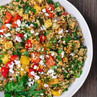 Mediterranean Roasted Vegetable Barley Recipe | The Mediterranean Dish. Easy, satisfying vegetarian barley recipe, prepared Mediterranean style. Tons of flavor from fresh herbs, spices and a simple zesty dressing. Perfect for meal prep. Recipe from TheMediterraneandish.com #barley #barleysalad #roastedvegetables #mediterraneandiet #mediterraneanfood