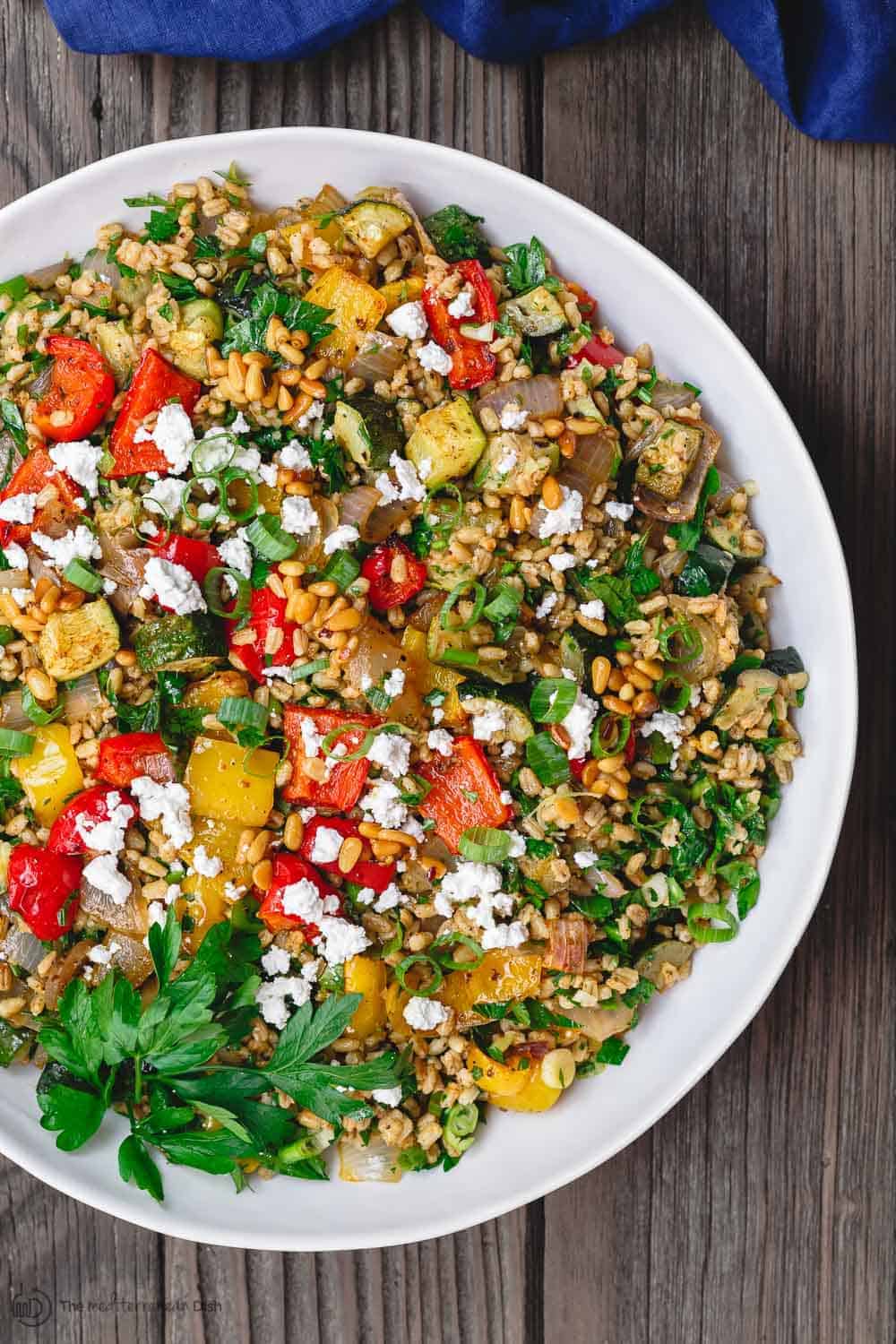 Mediterranean Roasted Vegetable Barley Recipe | The Mediterranean Dish. Easy, satisfying vegetarian barley recipe, prepared Mediterranean style. Tons of flavor from fresh herbs, spices and a simple zesty dressing. Perfect for meal prep. Recipe from TheMediterraneandish.com #barley #barleysalad #roastedvegetables #mediterraneandiet #mediterraneanfood