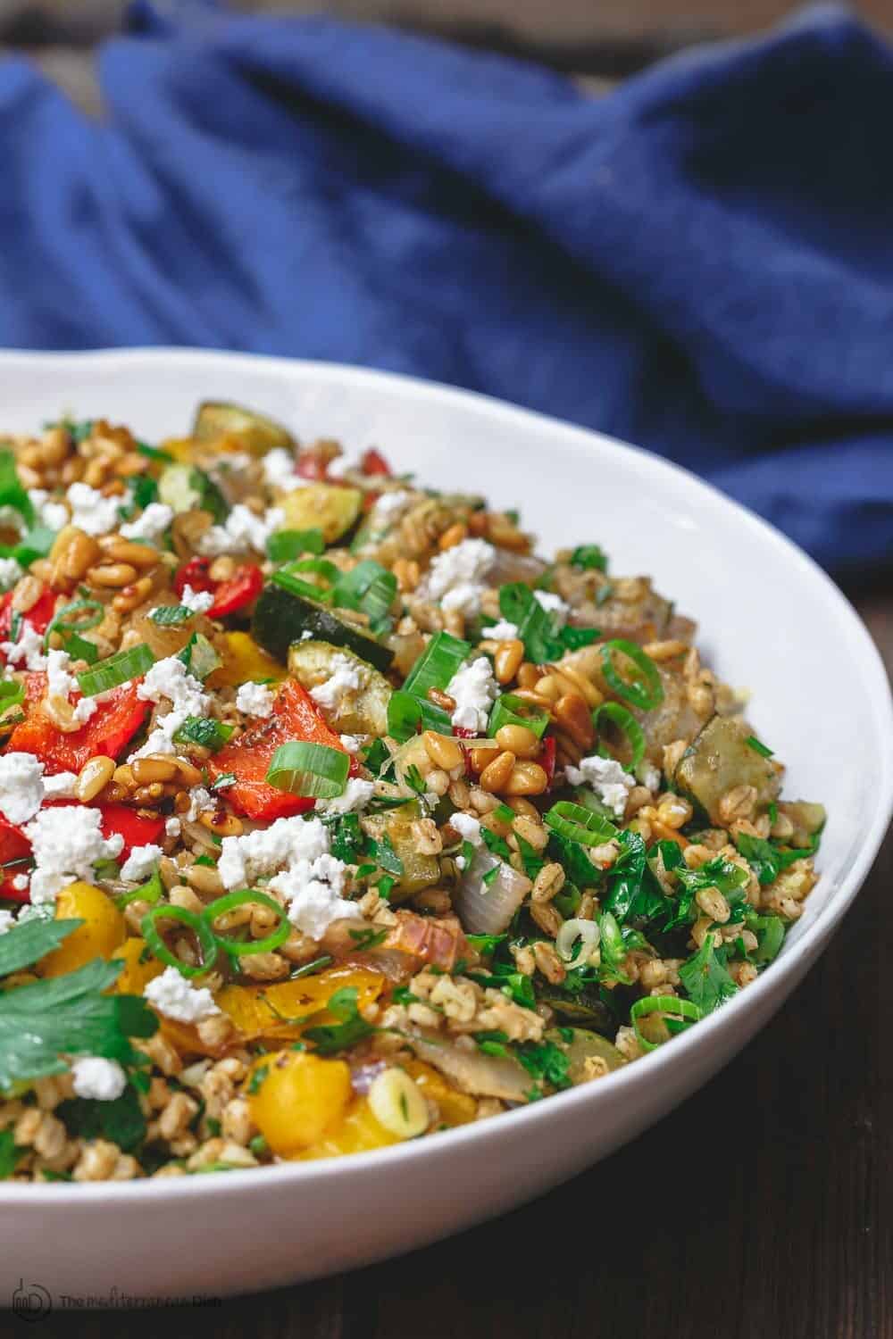 Mediterranean Roasted Vegetable Barley Recipe | The Mediterranean Dish. Easy, satisfying vegetarian barley recipe, prepared Mediterranean style. Tons of flavor from fresh herbs, spices and a simple zesty dressing. Perfect for meal prep. Recipe from TheMediterraneandish.com #barley #barleysalad #roastedvegetables #mediterraneandiet #mediterraneanfood