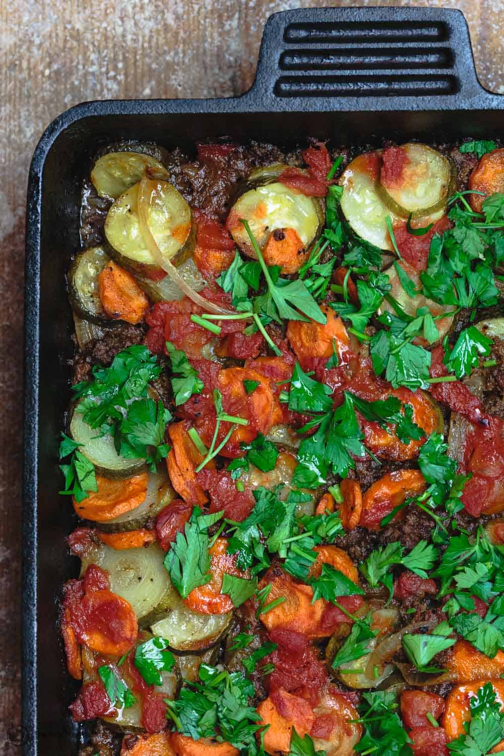 Mediterranean zucchini casserole with carrots, onions, and spiced ground beef sauce