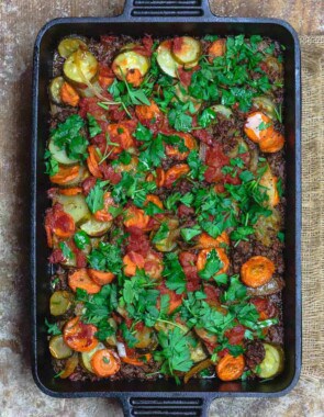 Mediterranean Style Zucchini Casserole | The Mediterranean Dish. Low carb zucchini casseroles with layers of zucchini, carrots, onions and a perfectly spiced meat sauce. Aromatics, warm Mediterranean spices, and fresh herbs make all the difference. See the full recipe on themediterraneandish.com #mediterraneandiet #zucchini #casserole #lowcarb #keto