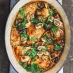 Wine braised chicken thighs with mushrooms and shallots in Dutch oven