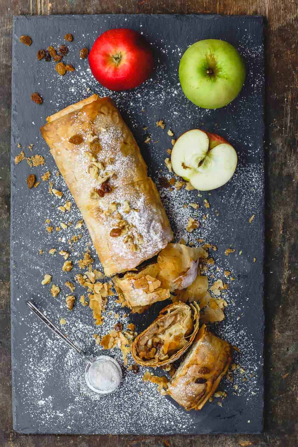 Phyllo apple strudel sliced. Granny smith and gala apples to the side.