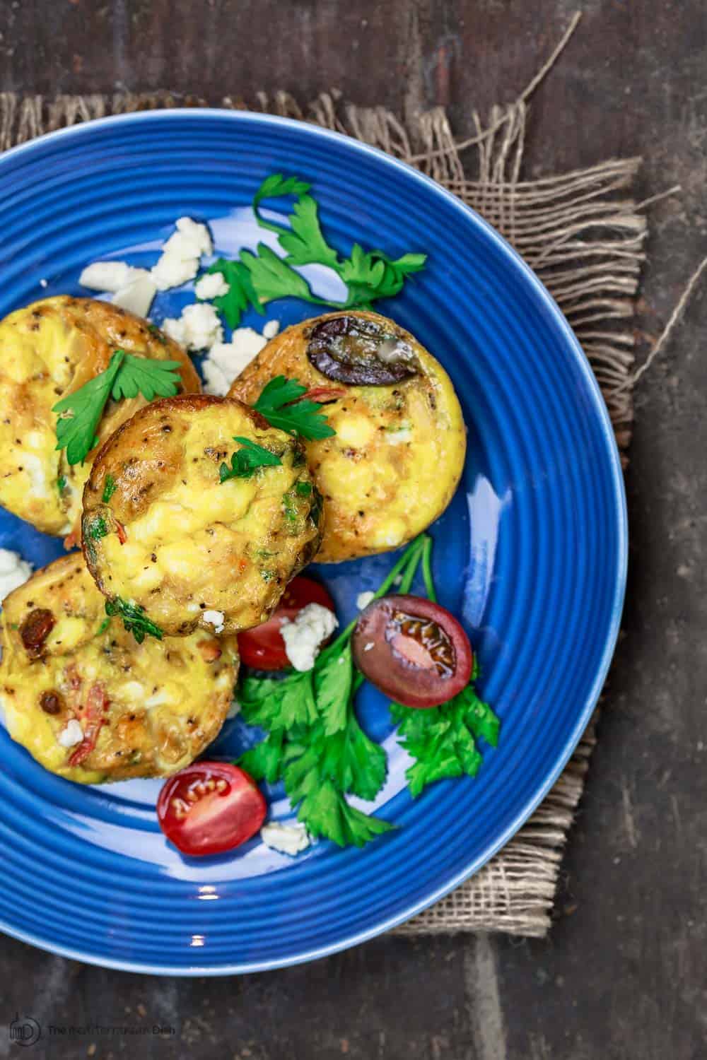 Mediterranean breakfast egg muffins served with tomatoes and feta