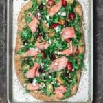 Mediterranean Flatbread, topped with Arugula, Tomatoes, Smoked Salmon and More