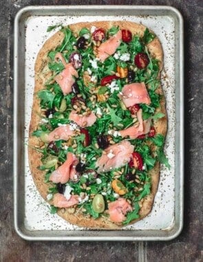 Mediterranean Flatbread, topped with Arugula, Tomatoes, Smoked Salmon and More