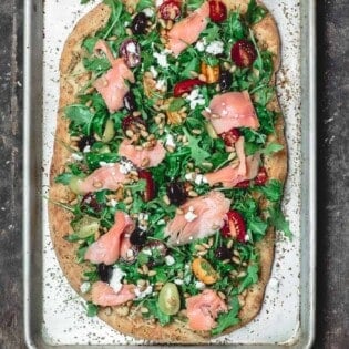 Mediterranean Flatbread, topped with Arugula, Tomatoes, Smoked Salmon and More