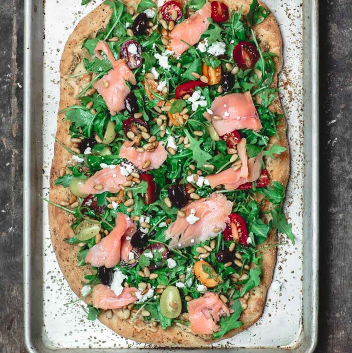 Mediterranean Flatbread, topped with Arugula, Tomatoes, Smoked Salmon and More