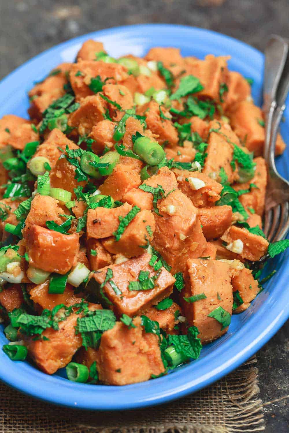 Simple sweet potato recipe with fresh herbs, garlic, scallions, and extra virgin olive oil 