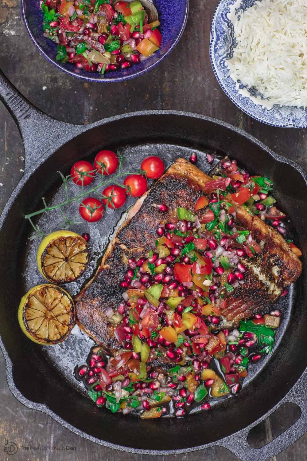 Mediterranean Blackened Salmon Served with Grilled Lemon Halves, Pomegranate Salsa and Rice